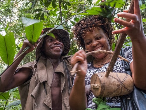 September 2017. The Batwa Pygmies were evicted from their home lands in the forest in the early 1990s when the National Parks were established, leaving them landless and poor in a society that saw them as a lower class. Today some of them try to make ends meet by hosting trail walks; cultural tours that include examples of where and how they use to live in the forest as well as singing, dancing, and handicrafts for sale. Buhoma, Uganda. Photograph by Jason Houston for USAID