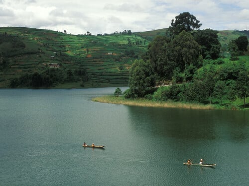 Goods are transported accross the lake in dugout canoes to be sold in the market, Lake Bunyonyi, Uganda